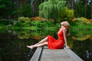 Femme assise sur un ponton d'un lac. Êtes-vous de tempérament zen?